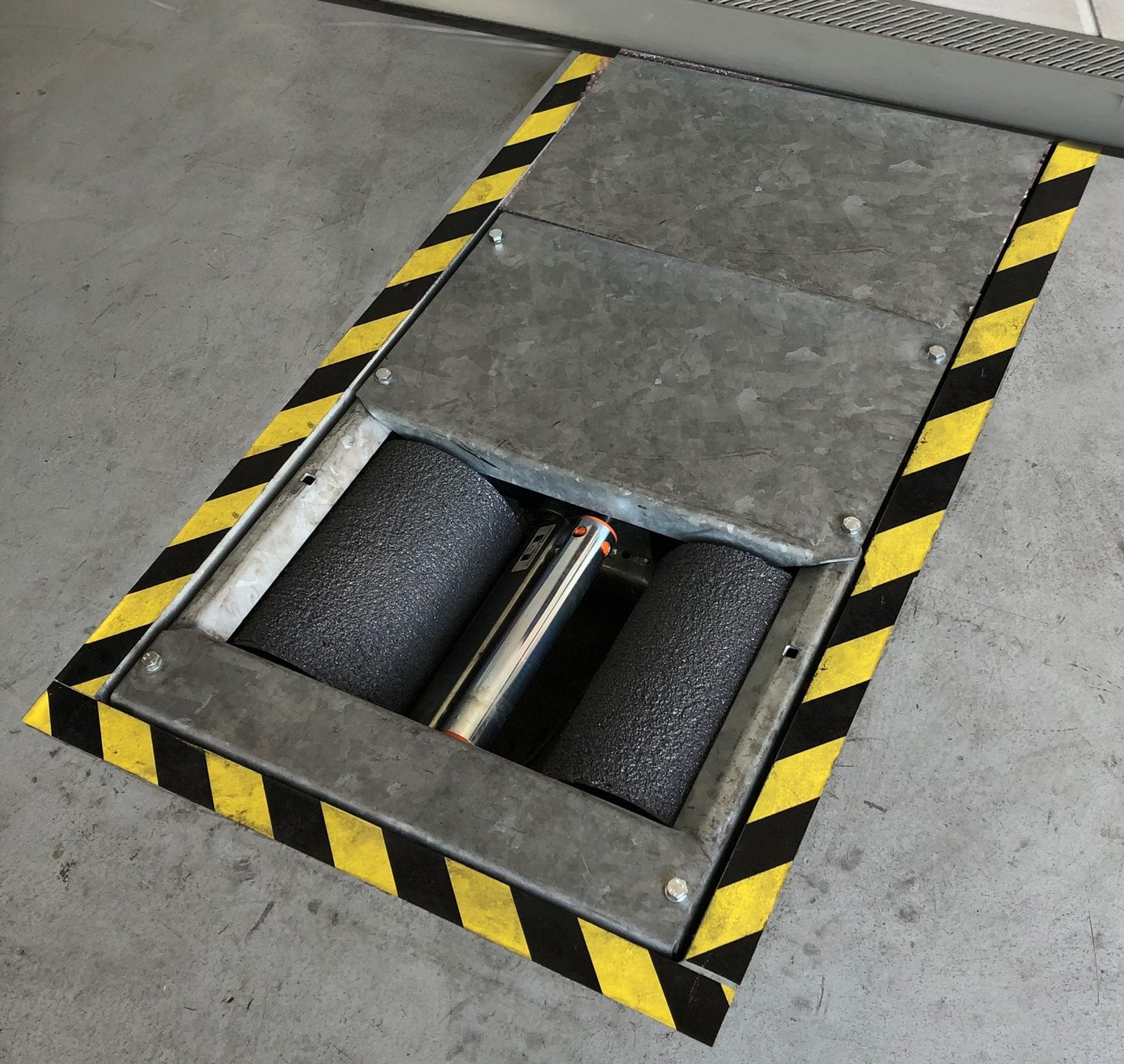 Motorcycle MOT bay with roller brake tester installed