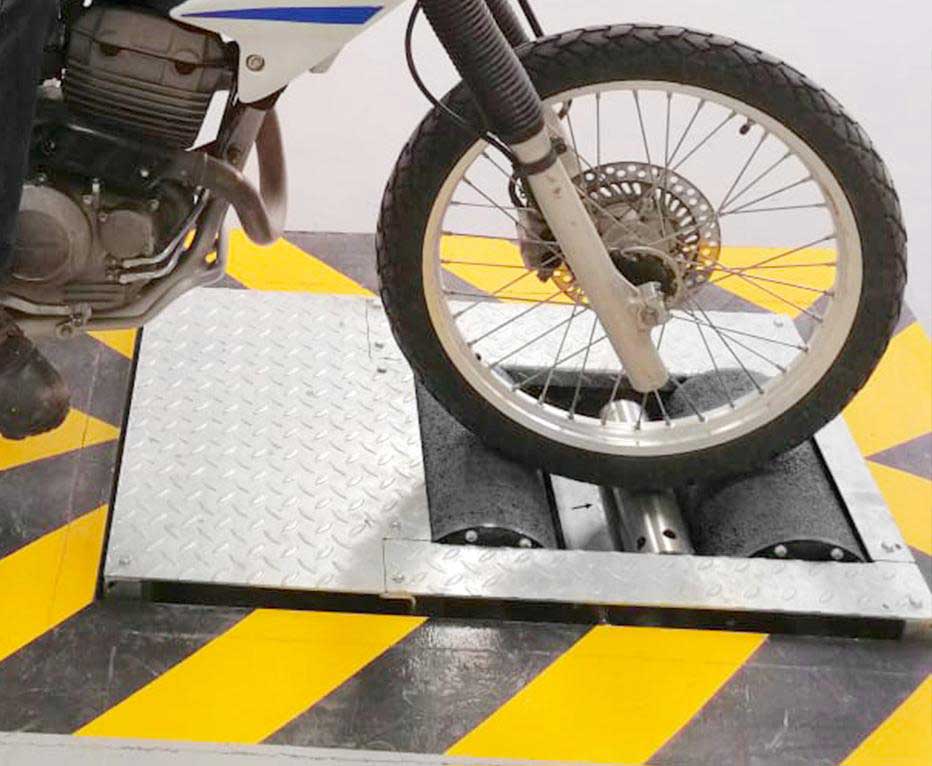 CAPELEC motorcycle roller brake tester in an MOT bay