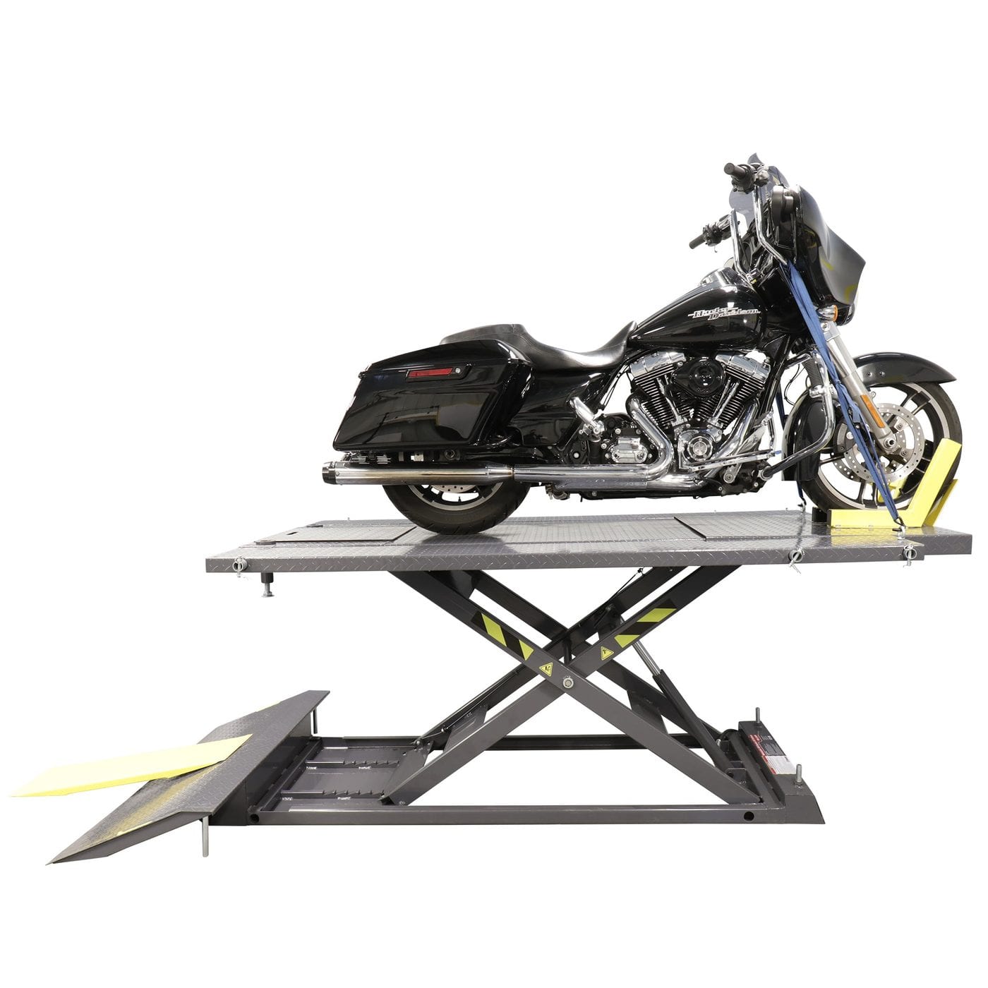 Motorcycle scissor lift raising a bike in a workshop